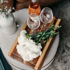 flowers and wine on a cutting board