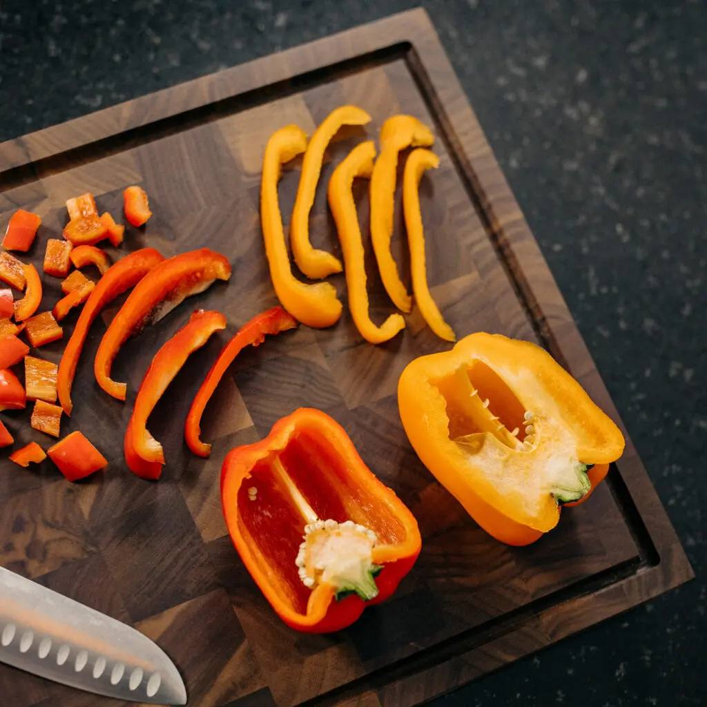 Walnut end grain cutting board with peppers
